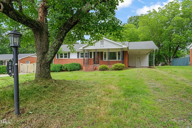 218 Forestville Rd, Wake Forest, NC 27587 - ranch-style home with a porch, brick siding, driveway, and an attached carport