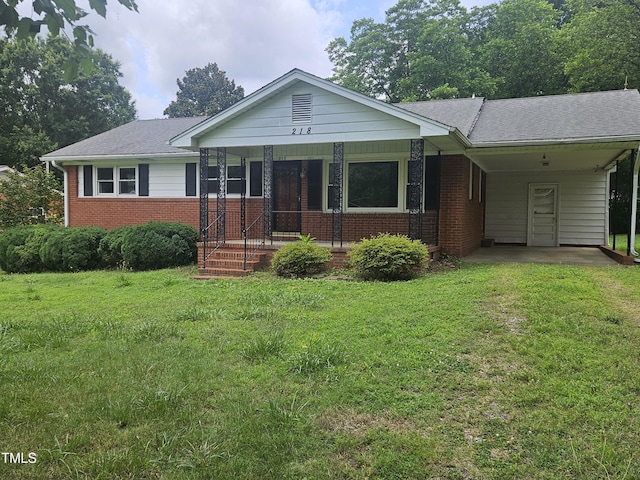 218 Forestville Rd, Wake Forest, NC 27587 - single story home featuring brick siding, covered porch, a front yard, a carport, and a shingled roof