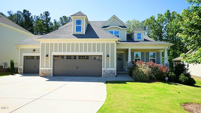 966 Airedale Trl, Garner, NC 27529 - craftsman-style home with an attached garage, board and batten siding, driveway, a front yard, and a shingled roof