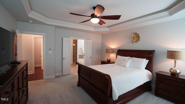 966 Airedale Trl, Garner, NC 27529 - bedroom featuring a raised ceiling, crown molding, light carpet, ceiling fan, and connected bathroom