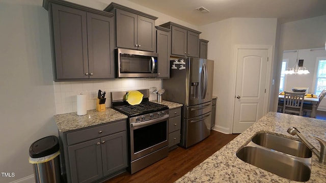 966 Airedale Trl, Garner, NC 27529 - kitchen featuring stainless steel appliances, dark wood-style floors, tasteful backsplash, and light stone counters