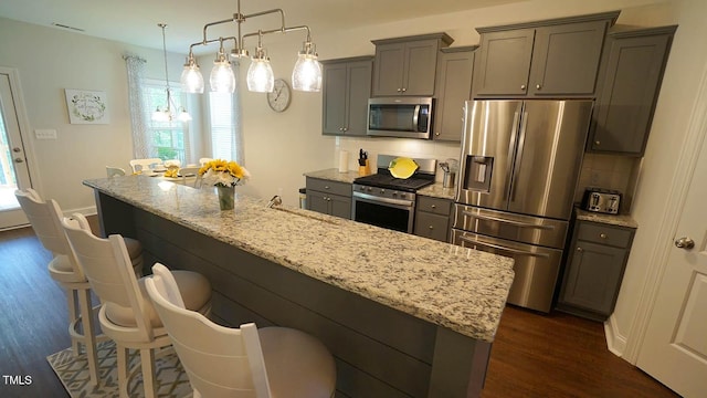 966 Airedale Trl, Garner, NC 27529 - kitchen with appliances with stainless steel finishes, gray cabinets, plenty of natural light, and dark wood-type flooring