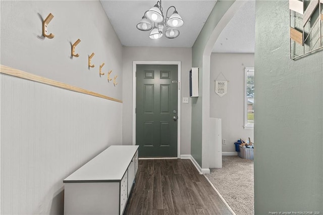 6108 Lonestar Rd, Fayetteville, NC 28303 - entryway with arched walkways, a chandelier, and dark wood-style floors