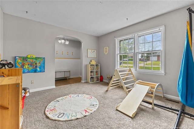6108 Lonestar Rd, Fayetteville, NC 28303 - rec room featuring arched walkways, carpet flooring, a textured ceiling, and a chandelier
