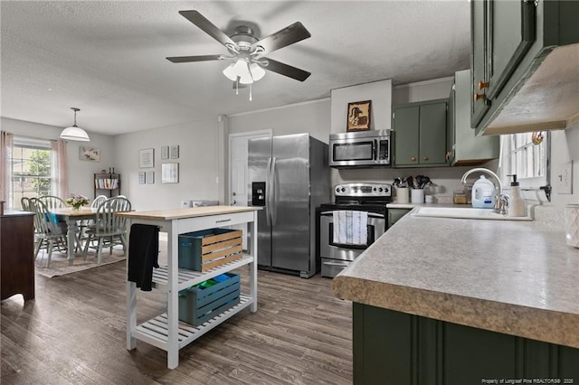 6108 Lonestar Rd, Fayetteville, NC 28303 - kitchen featuring stainless steel appliances, light countertops, dark wood finished floors, a textured ceiling, and a ceiling fan