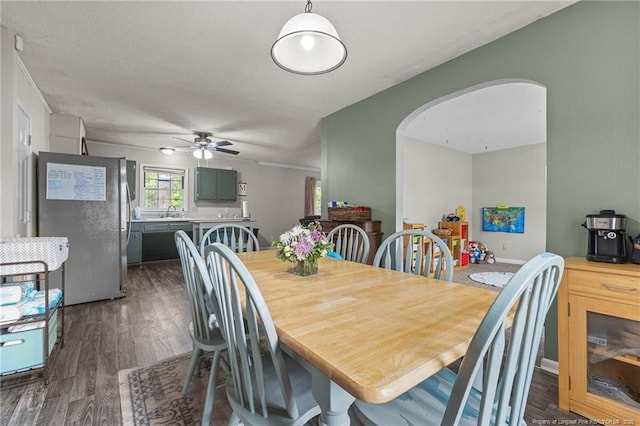 6108 Lonestar Rd, Fayetteville, NC 28303 - dining space with dark wood-type flooring, arched walkways, and ceiling fan