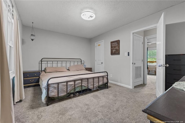 6108 Lonestar Rd, Fayetteville, NC 28303 - bedroom featuring a textured ceiling and carpet floors