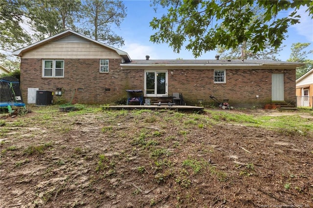 6108 Lonestar Rd, Fayetteville, NC 28303 - rear view of house featuring a trampoline, brick siding, and crawl space