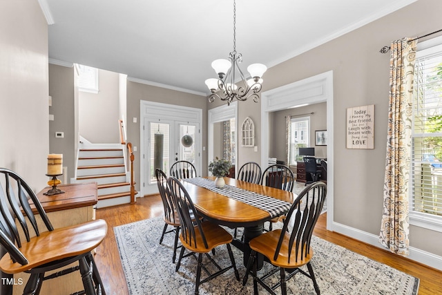 124 Kingsport Rd, Holly Springs, NC 27540 - dining area featuring stairs, plenty of natural light, crown molding, and a chandelier