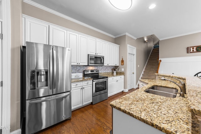 124 Kingsport Rd, Holly Springs, NC 27540 - kitchen featuring appliances with stainless steel finishes, white cabinetry, crown molding, backsplash, and dark wood-style floors