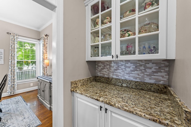 124 Kingsport Rd, Holly Springs, NC 27540 - bar area with backsplash, dark wood finished floors, and ornamental molding