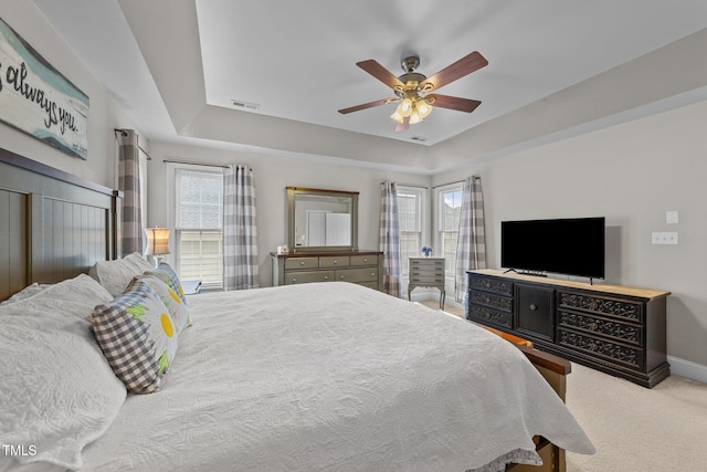 124 Kingsport Rd, Holly Springs, NC 27540 - carpeted bedroom featuring a tray ceiling and a ceiling fan