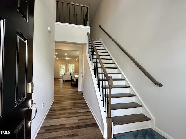 2417 Tobacco Root Dr, Raleigh, NC 27616 - staircase with wood finished floors and a towering ceiling