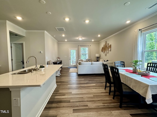 2417 Tobacco Root Dr, Raleigh, NC 27616 - dining area featuring plenty of natural light, dark wood-style floors, ornamental molding, and recessed lighting