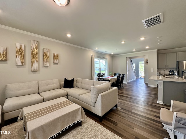 2417 Tobacco Root Dr, Raleigh, NC 27616 - living room with recessed lighting, crown molding, and dark wood-style floors