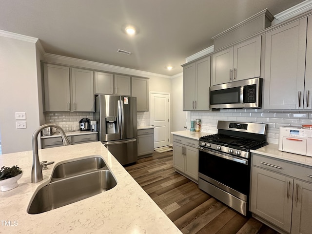 2417 Tobacco Root Dr, Raleigh, NC 27616 - kitchen featuring stainless steel appliances, gray cabinets, crown molding, dark wood-style floors, and recessed lighting