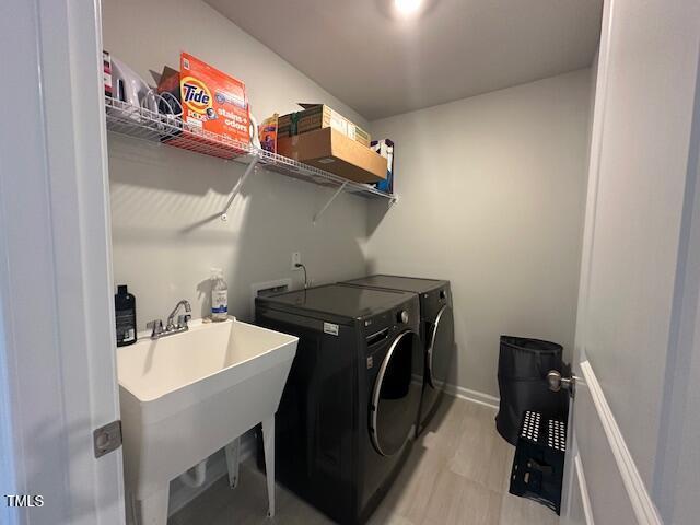 2417 Tobacco Root Dr, Raleigh, NC 27616 - laundry area with washer and clothes dryer and baseboards