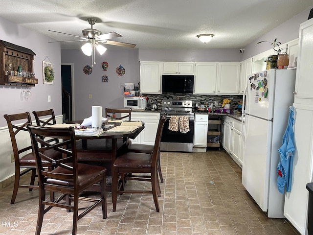 3129 Skycrest Dr, Raleigh, NC 27604 - kitchen with white appliances, tasteful backsplash, white cabinetry, dark countertops, and a ceiling fan