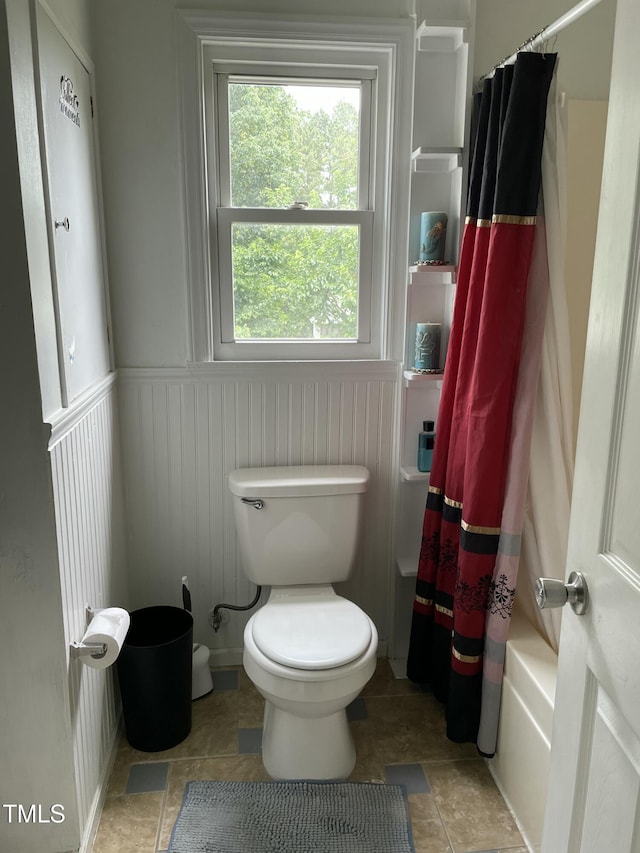 3129 Skycrest Dr, Raleigh, NC 27604 - bathroom featuring a wainscoted wall and shower / tub combo with curtain