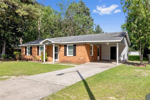 6547 Amanda Cir, Fayetteville, NC 28304 - ranch-style house featuring concrete driveway, a front yard, a carport, and brick siding