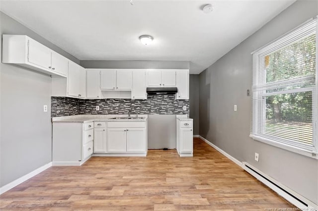 6547 Amanda Cir, Fayetteville, NC 28304 - kitchen with baseboard heating, under cabinet range hood, plenty of natural light, and decorative backsplash