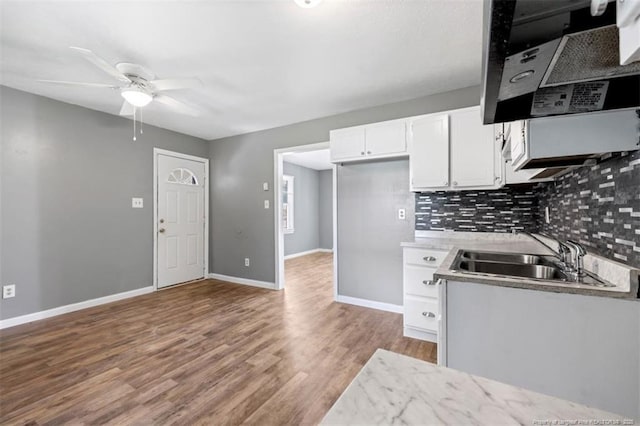 6547 Amanda Cir, Fayetteville, NC 28304 - kitchen featuring extractor fan, backsplash, wood finished floors, ceiling fan, and white cabinets