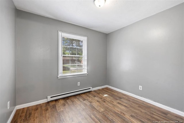 6547 Amanda Cir, Fayetteville, NC 28304 - unfurnished room featuring a baseboard heating unit and wood finished floors