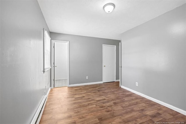 6547 Amanda Cir, Fayetteville, NC 28304 - spare room featuring a baseboard radiator and wood finished floors
