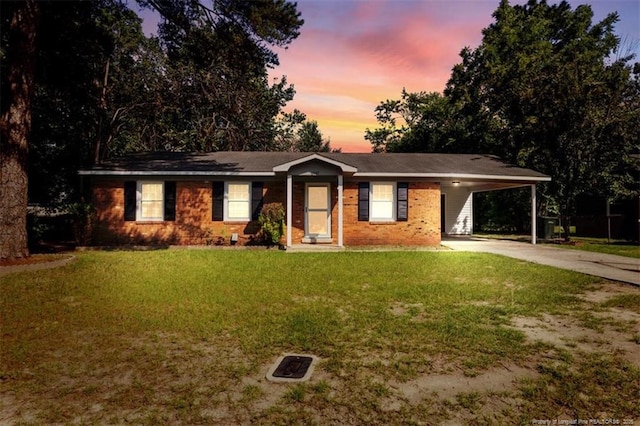 6547 Amanda Cir, Fayetteville, NC 28304 - ranch-style home featuring driveway, a lawn, an attached carport, and brick siding