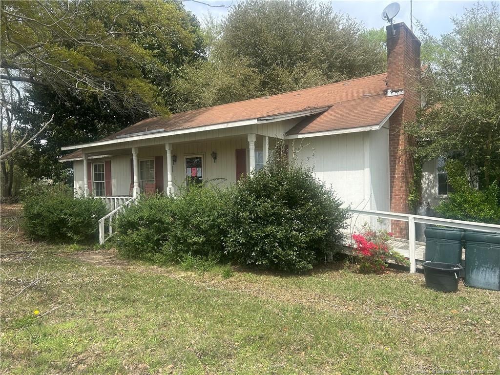 1580 Arthur Rd, Red Springs, NC 28377 - view of front of property featuring a front yard, a chimney, and a porch