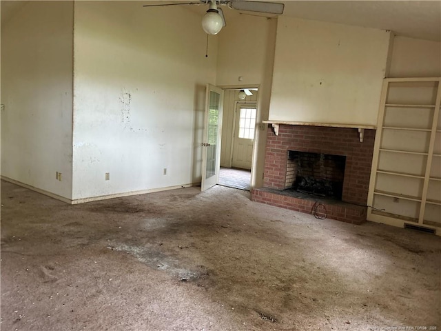 1580 Arthur Rd, Red Springs, NC 28377 - unfurnished living room with a ceiling fan, a fireplace, a towering ceiling, and unfinished concrete flooring