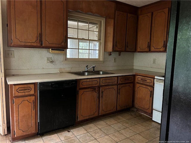 1580 Arthur Rd, Red Springs, NC 28377 - kitchen with black dishwasher, stove, light countertops, and brown cabinets