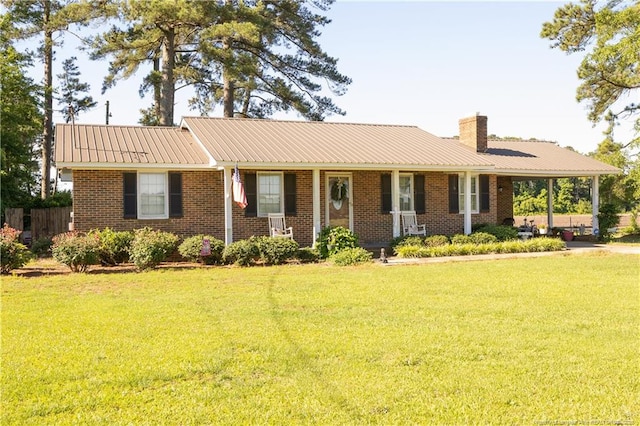 6733 Newton Grove Hwy, Newton Grove, NC 28366 - single story home featuring a front yard, a chimney, a metal roof, and brick siding