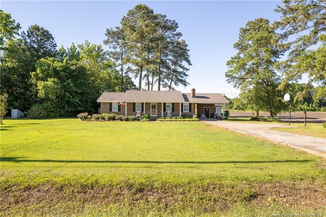 6733 Newton Grove Hwy, Newton Grove, NC 28366 - ranch-style house featuring a front lawn, concrete driveway, and a metal roof