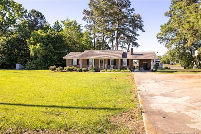 6733 Newton Grove Hwy, Newton Grove, NC 28366 - single story home featuring driveway, a chimney, a front yard, and a metal roof