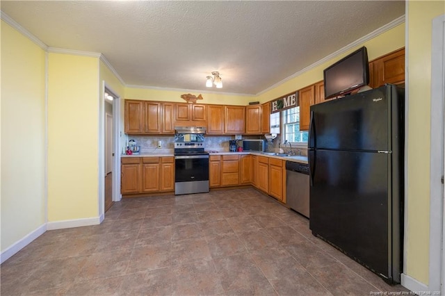 6733 Newton Grove Hwy, Newton Grove, NC 28366 - kitchen with stainless steel appliances, crown molding, under cabinet range hood, light countertops, and decorative backsplash