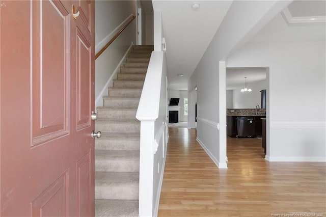 229 Red Oak Ct, Raeford, NC 28376 - entryway with stairs, light wood-style flooring, a fireplace, and a chandelier