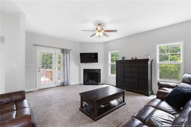 229 Red Oak Ct, Raeford, NC 28376 - carpeted living area featuring ceiling fan and a fireplace with flush hearth