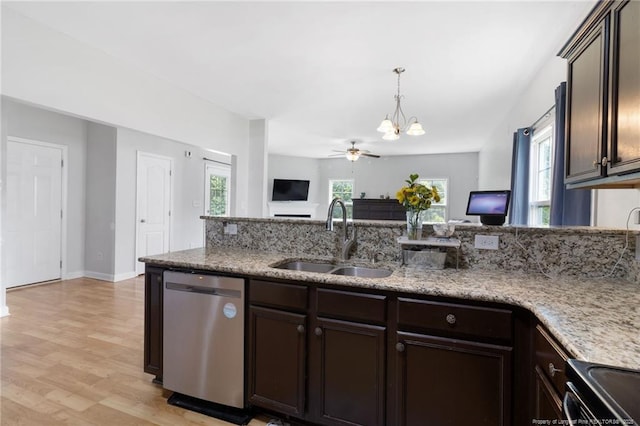 229 Red Oak Ct, Raeford, NC 28376 - kitchen featuring dishwasher, dark brown cabinets, open floor plan, a chandelier, and light stone counters