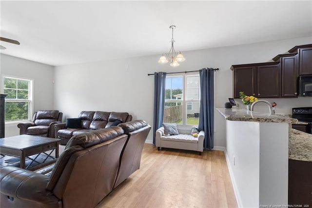 229 Red Oak Ct, Raeford, NC 28376 - living area featuring light wood-style floors, a chandelier, and ceiling fan