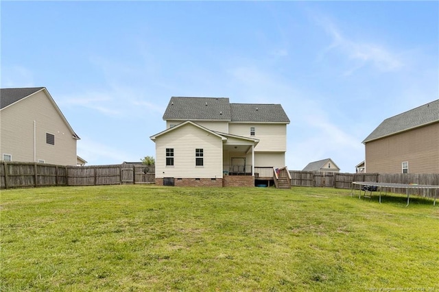 229 Red Oak Ct, Raeford, NC 28376 - back of property featuring a trampoline, a fenced backyard, crawl space, and a wooden deck
