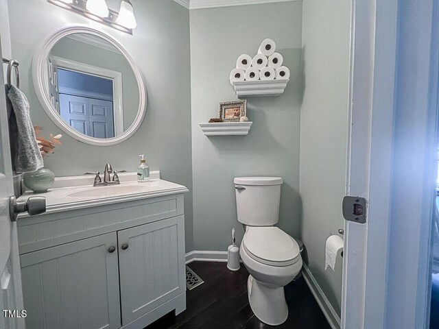 5500 Fortunes Ridge Dr Unit 94C, Durham, NC 27713 - half bath featuring vanity, wood finished floors, and ornamental molding