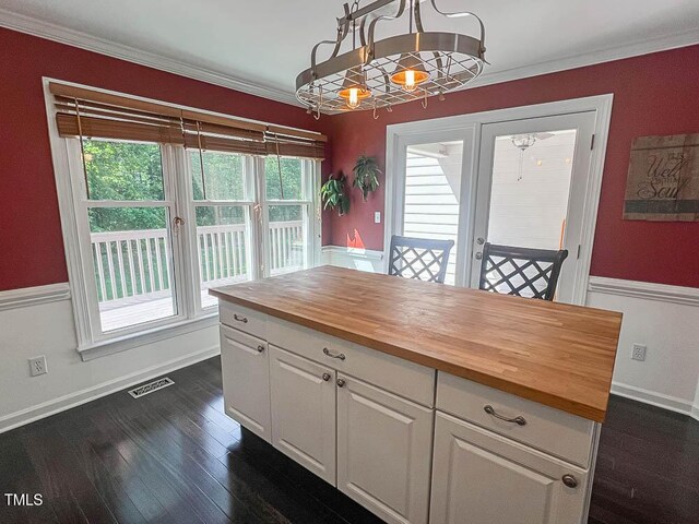 5500 Fortunes Ridge Dr Unit 94C, Durham, NC 27713 - kitchen featuring wooden counters, a chandelier, dark wood finished floors, white cabinets, and crown molding