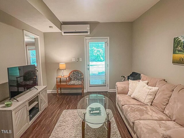 5500 Fortunes Ridge Dr Unit 94C, Durham, NC 27713 - living area featuring a wall unit AC, plenty of natural light, and dark wood-style floors
