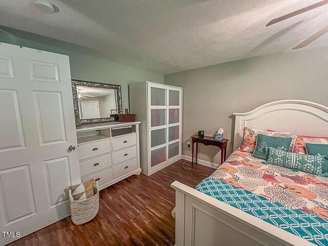 5500 Fortunes Ridge Dr Unit 94C, Durham, NC 27713 - bedroom with dark wood-style floors, a textured ceiling, and a ceiling fan