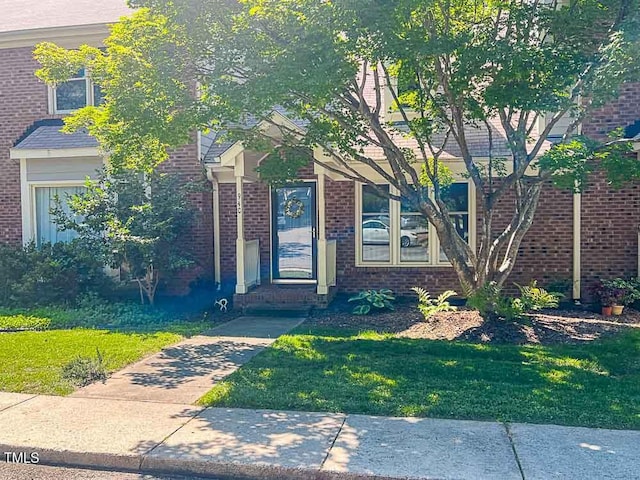 5500 Fortunes Ridge Dr Unit 94C, Durham, NC 27713 - view of front of house featuring brick siding and a front yard