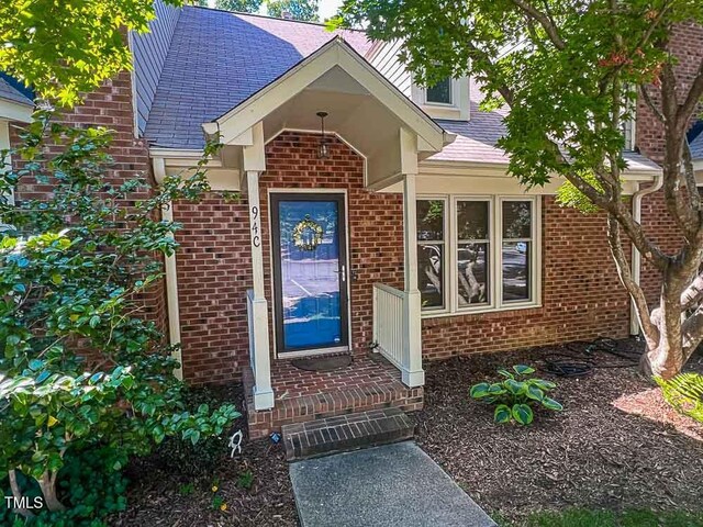 5500 Fortunes Ridge Dr Unit 94C, Durham, NC 27713 - view of exterior entry featuring brick siding and roof with shingles