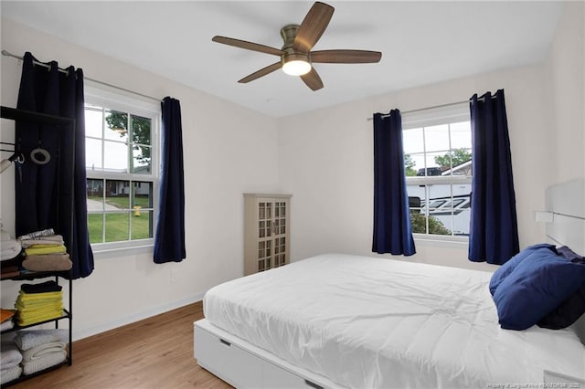 262 Shads Ford Blvd, Fayetteville, NC 28314 - bedroom with multiple windows, wood finished floors, and ceiling fan