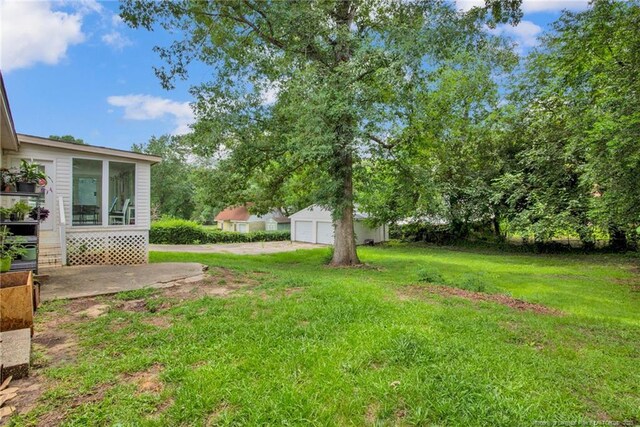 262 Shads Ford Blvd, Fayetteville, NC 28314 - view of green lawn with a detached garage