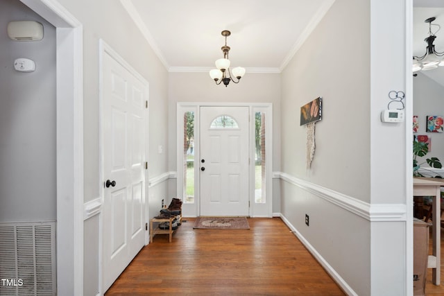 5405 Doemont Dr, Apex, NC 27539 - foyer with a chandelier, ornamental molding, and wood finished floors